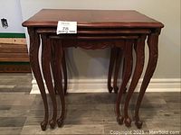 Front view photo showing all three nested tables with carved legs and veneer tops