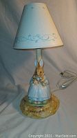 Full view of ceramic Mother Bunny lamp with original shade and cord visible