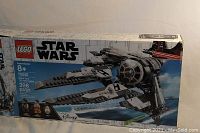 Box of Lego Star Wars 75242 Black Ace TIE Interceptor showing front panel with set image and piece count