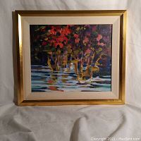 Framed oil painting showing an abstract floral scene with rich colors and reflections in water