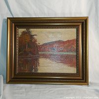 Full front view of framed oil painting showing landscape scene and signature area