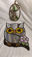 Stained glass owl and hummingbird artworks together