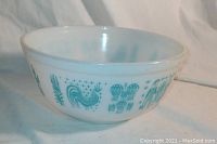 Close-up angle emphasizing the roosters, corn stalks, and floral patterns on white milk glass.