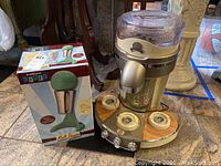 Margaritaville margarita maker and Salton Diner malt shake maker in original box shown from side view.