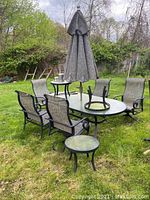 Full set on grass: table, chairs, side tables and umbrella.