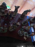 Overhead view of multiple ceramic figurines including angels, children, and adults in various poses