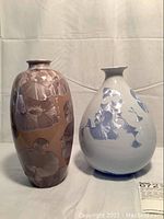 Front view of both brown and blue crystalline glazed vases side by side.