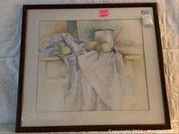 Full view of the framed watercolor painting showing apples and peaches with draped cloth, signed and dated 1970.
