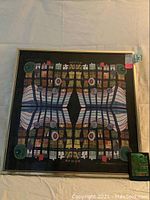 Framed polychrome print variation after Hundertwasser showing the full artwork with colorful abstract elements and black frame.