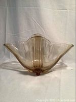 Front view showing ruffled flared edges and ribbed body