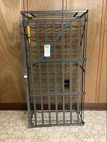 Front view of full wine rack showing frame, wavy bottle supports, and locking door