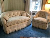 Loveseat and matching armchair set in room setting, showing overall design and scale