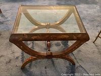 Full top view of rectangular glass top on wooden marquetry frame table