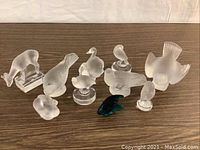 Group shot of frosted clear animal figurines with teal-blue fish