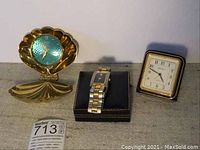 Wide view of all three timepieces on fabric background showing general condition