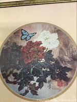 Close-up of circular floral print with butterfly signed by T.C. Chiu.