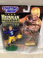 Starting Lineup 1998 Heisman Collection Joe Montana football figurine in original packaging with small gold trophy.