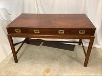 Front view of full desk showing overall shape, leg structure and drawer arrangement