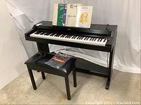 Full view of Korg Concert 2500 digital piano on stand with bench and selected music books displayed on music rest