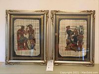 Pair of framed Greek papyri showing heroes and gods, mounted on black board with Greek key border, in silver and gold painted wood frames.