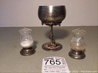 All three pieces displayed together: wine goblet center, salt and pepper shakers at sides