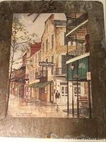 Close-up of the painted slate showing detailed New Orleans street scene and marking of Absinthe House Bar