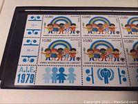 Close-up of a colorful United Nations Geneva stamp sheet featuring International Children's Year 1979 design with children and rainbow graphics.