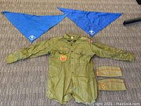 Full set including vintage olive green Boy Scouts shirt with patches, two blue scarfs, and two olive green hats