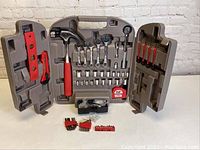 Full view of the open tool kit case showing hammer, wrenches, sockets, screwdrivers, and tape measure.
