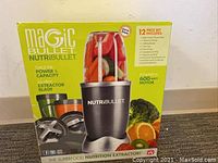 Front view of the Magic Bullet NutriBullet 12-piece set box showing product image and main features.
