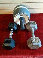 Image showing the 10-pound black dumbbell, 20-pound gray dumbbell, and the Perfect Ab Carver abdominal exercise wheel