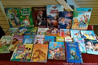 Photo showing an array of Disney children's books including Lion King, Cinderella, Toy Story, Bambi, Cars, Little Mermaid, Bugs Life, Snow White, and others.