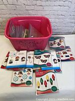 Full lot with pink bin labeled 'chocolate molds' containing multiple mold packages and some loose molds.