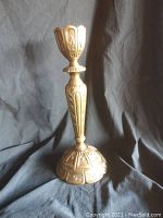 Full view of solid brass candle stick showing height and base design.