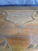 Close-up photo of embossed inscription plaque describing the map and its creation date (1569).