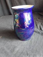 Side view showing the vase's blue opalescent glaze and the shape with rounded body and wide lip