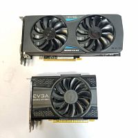 Top-down view of both cards on white background showing dual-fan GTX 970 at top and single-fan GTX 1050 Ti below