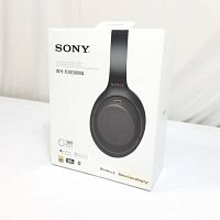 Front of sealed retail box with image of black WH-1000XM4 headphones and feature icons