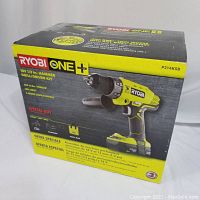 Box front showing Ryobi ONE+ hammer drill/driver kit with key features and model number P214KSB.