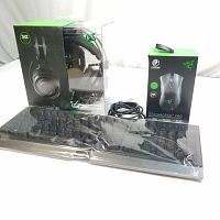 Three items: the headset in box, mouse in box, and keyboard covered in plastic