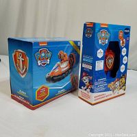Two Paw Patrol toys in original boxes: Marshall Learning Watch and Zuma Hovercraft