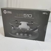 Box front showing Holy Stone HS510 brushless foldable drone with GPS, 14+ age recommendation, and drone image
