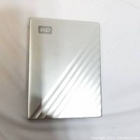 Top view of WD My Passport Ultra external hard drive showing silver metallic finish with diagonal striped textured pattern and WD logo.