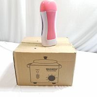 Photo of the pink and white wax heater placed on top of its cardboard box with product branding and controls illustration.