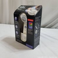 Box showing Braun No Touch + Forehead Thermometer with product features and branding.