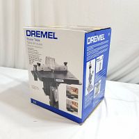 Photo of front and side panel of sealed Dremel Router Table box showing product name, image and brand.