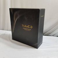 Black box of 11K & CO professional hairdryer with gold foil logo and text