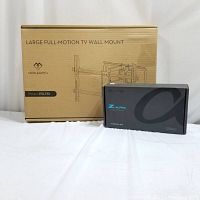 Both large full-motion TV wall mount box and Z Alpha PhD media streamer box placed side by side on white surface