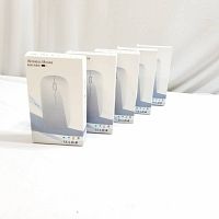 Five sealed boxes of wireless mice displayed side by side on a white surface.