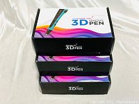 Three stacked boxes of Ataraxia Art 3D Printing Pen showing colorful branding.